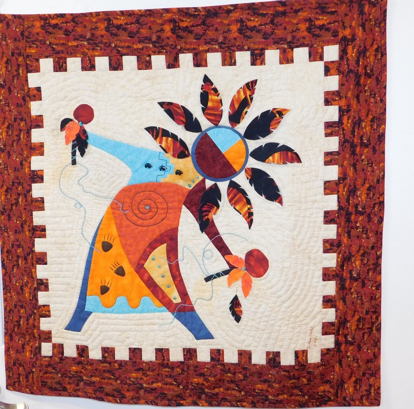 Arlene Walsh southwest pattern and fabric kit features spirit dancer, rattles, feathers, applique, pieced border. Kit material will differ from pattern photo.